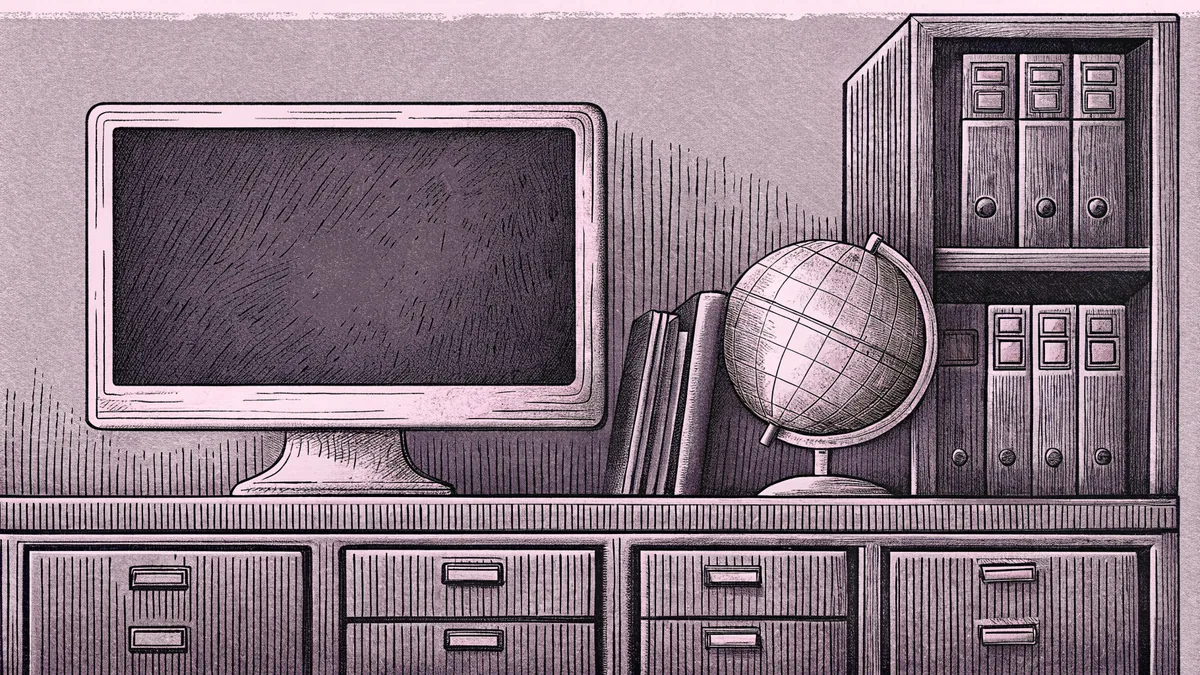 A computer monitor and globe sit on a desk beside a metal filing cabinet.
