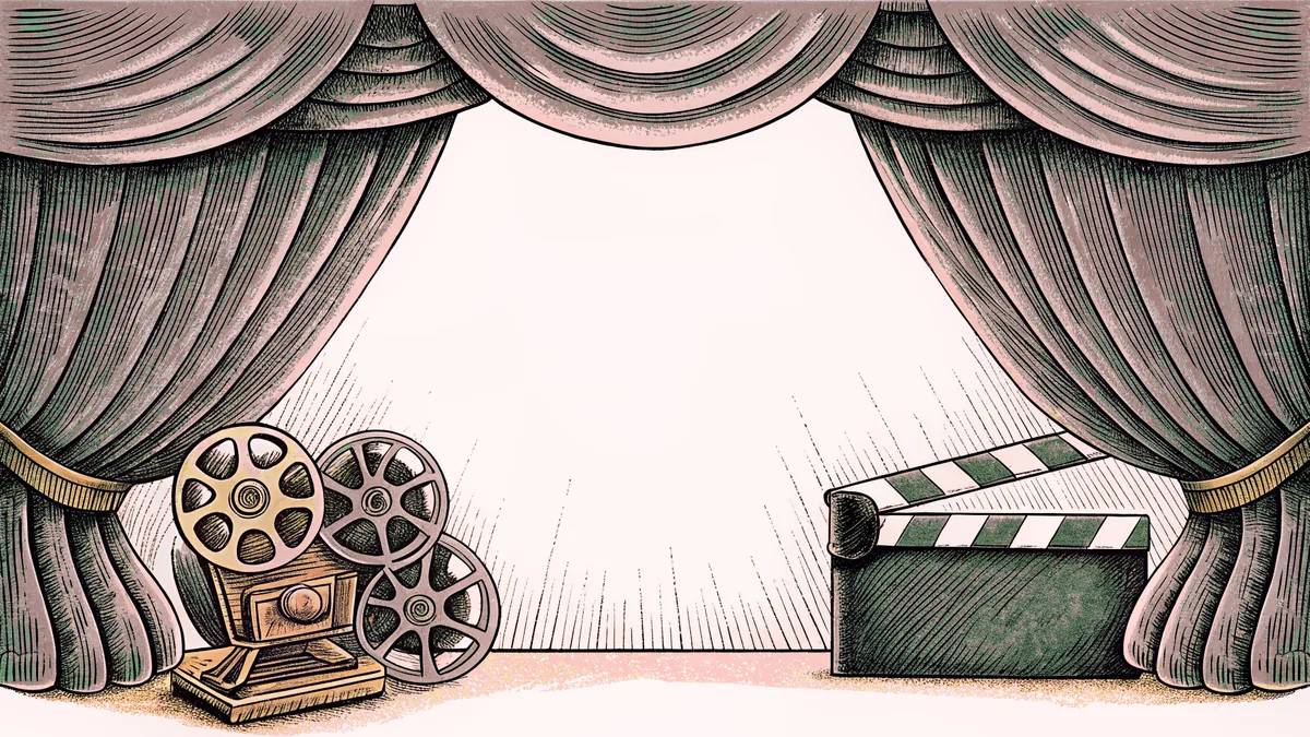 Cinema equipment including a projector lens and blank clapper board lit by stage spotlights.