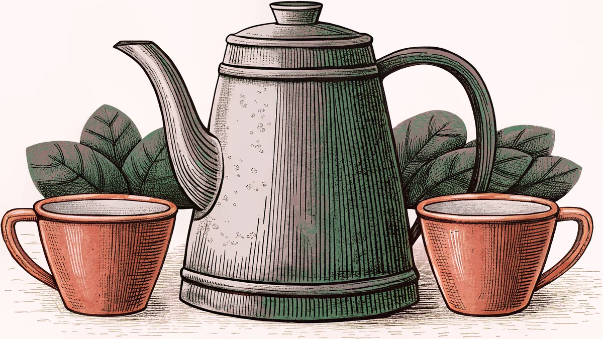 A brass coffee pot with a long curved spout beside two small cups.