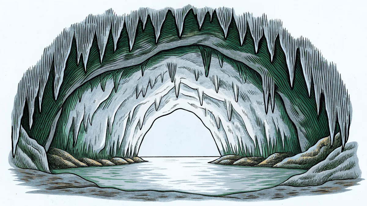 A cave interior with dramatic stalactites hanging above crystal-clear underground water.
