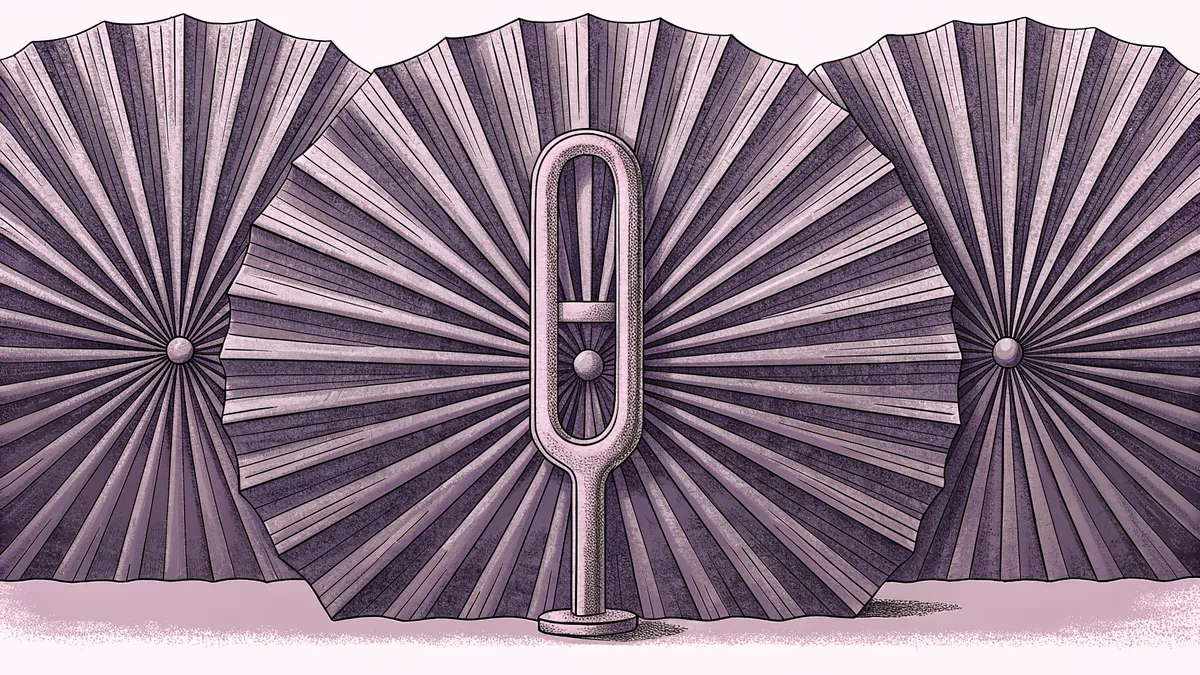 A brass tuning fork beside three folded paper fans arranged in a row.