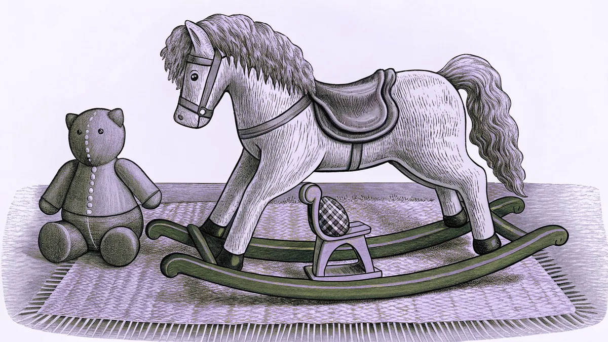 A rocking horse stands on a nursery rug beside a spinning top and a cloth doll.