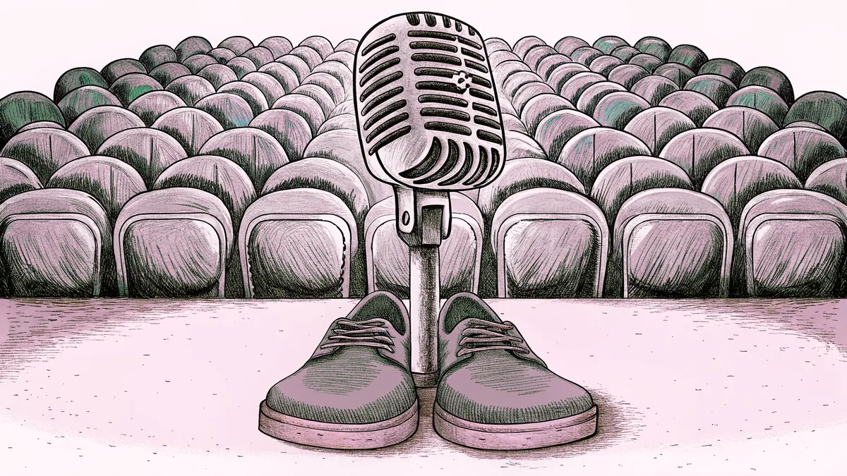 A pair of suede shoes beside a chrome microphone.