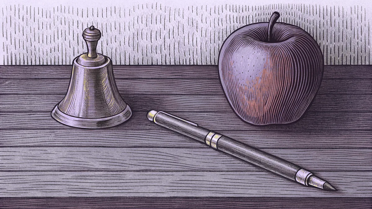 A brass school bell, a fountain pen and a red apple rest together on a dark wooden desk.