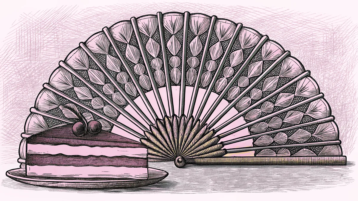 A slice of cheesecake topped with cherries, beside a pleated paper fan.