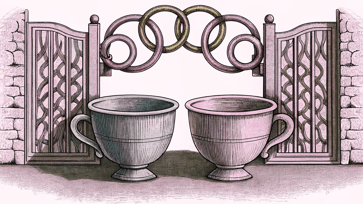 Two cups sit on a table beside a pair of linked paper rings and an open garden gate.