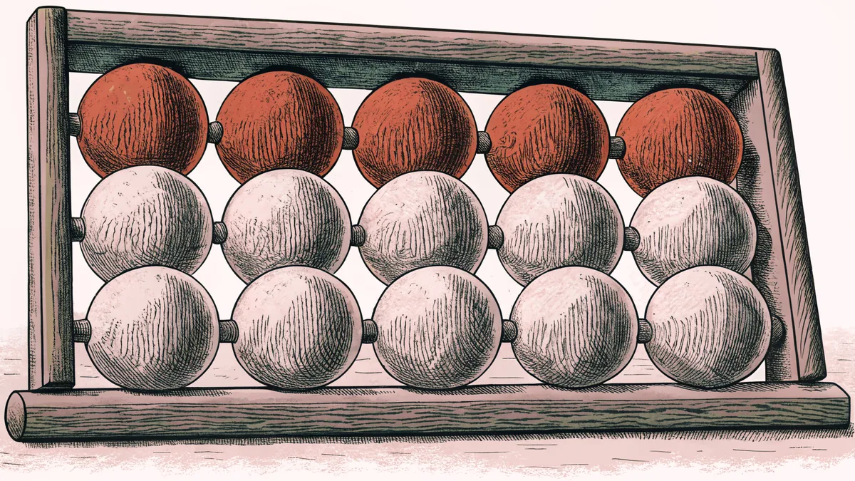 A wooden abacus strung with rows of red and white beads.