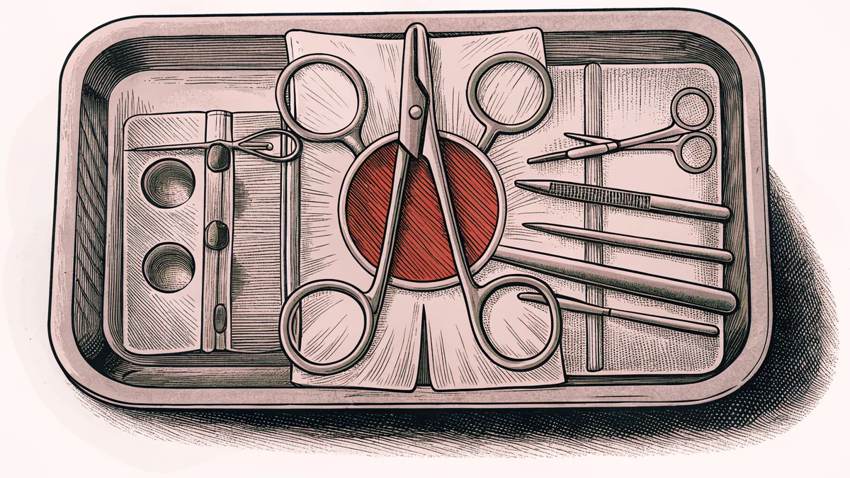 Surgical instruments including a scalpel and curved sutures lie on a steel tray under a bright lamp.
