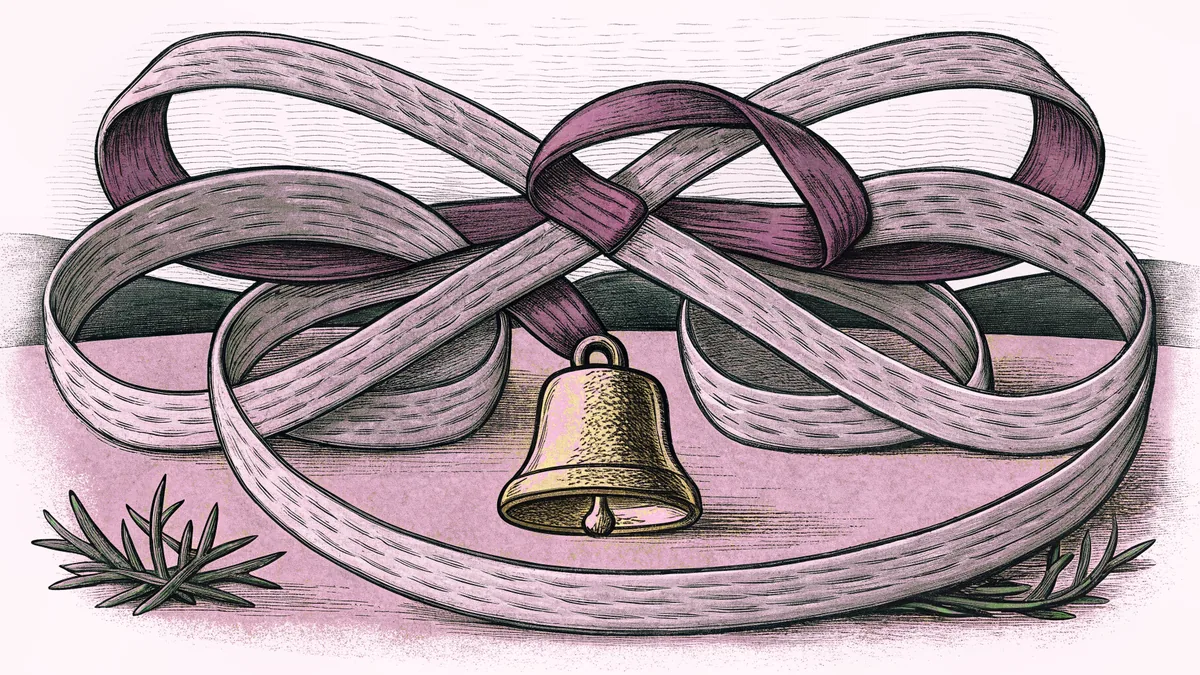 A looped green ribbon beside a small brass bell.