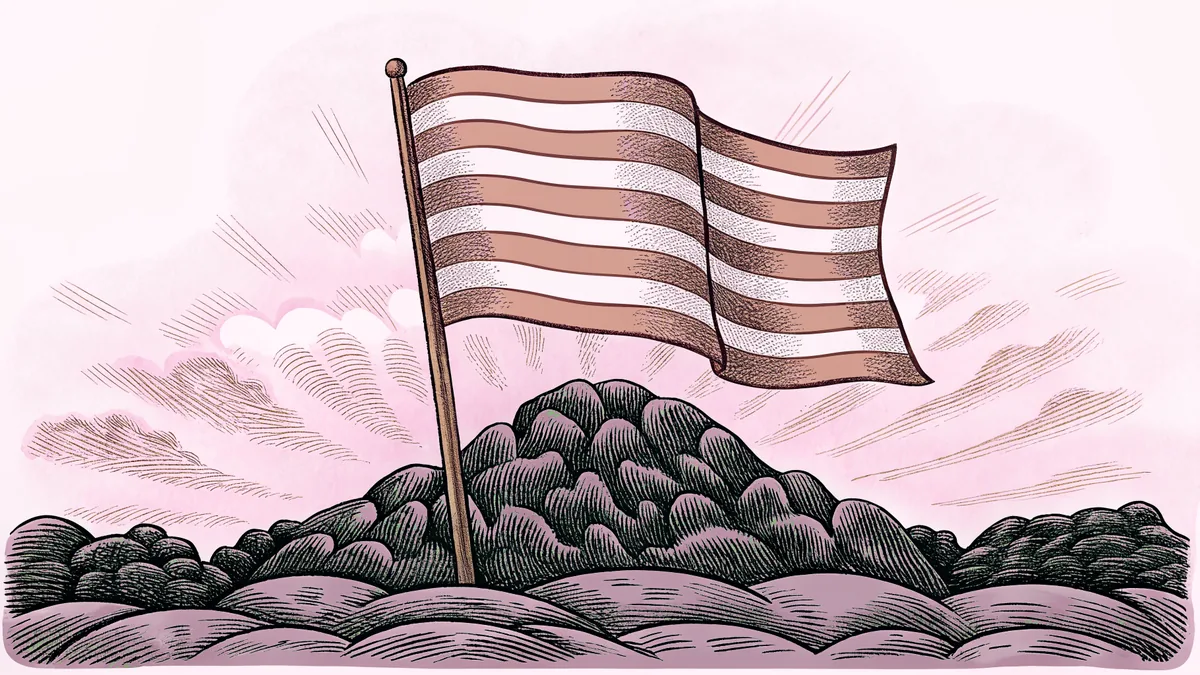 A plain flag stands atop a rocky mountain summit as the sun rises behind it.