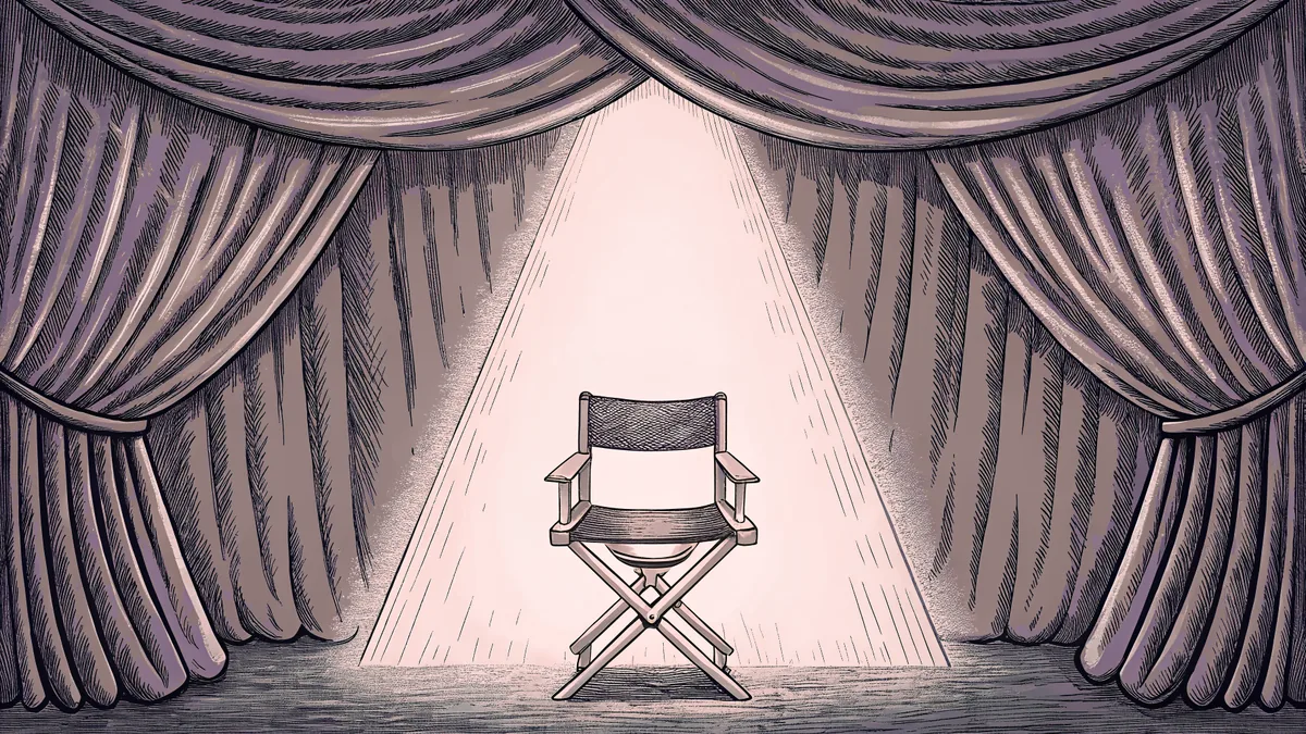 A theatrical spotlight illuminates a leather director's chair positioned in front of soft, draped velvet curtains.