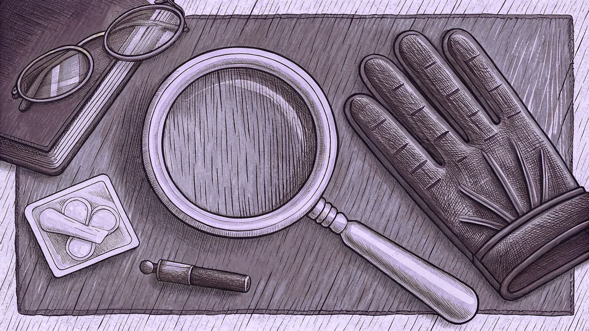 A magnifying glass lying across a leather glove on a worn desk, beside round spectacles, a closed notebook and a small open case.