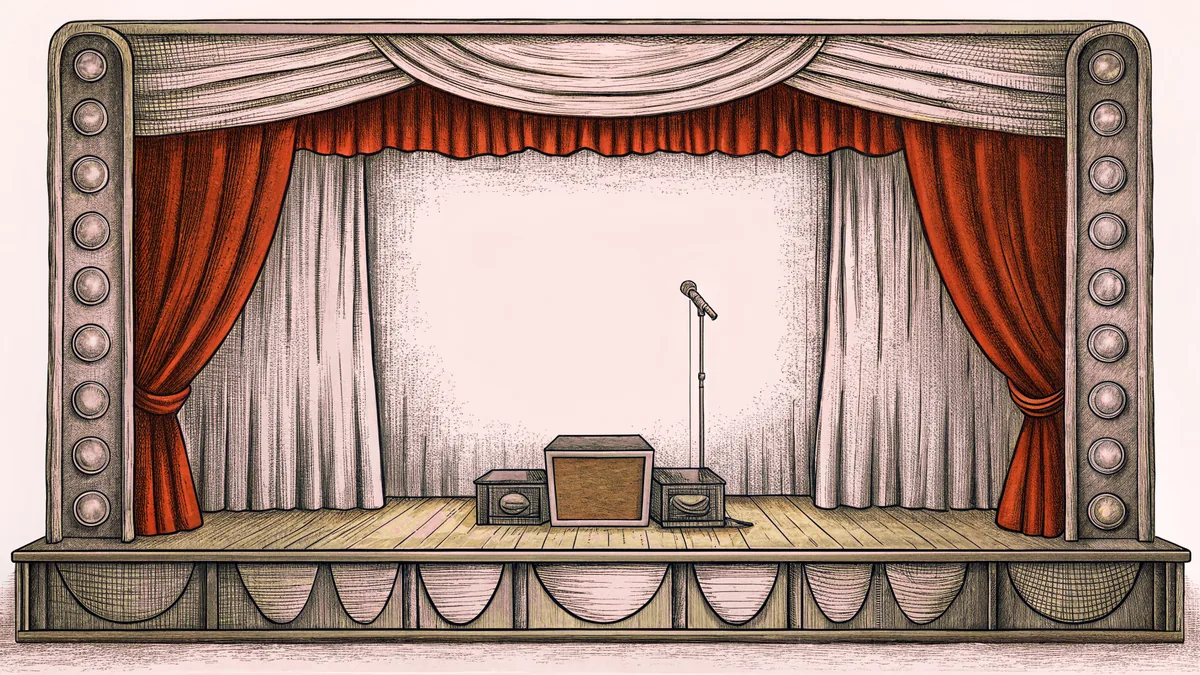 A music box, vinyl records, and vintage microphone stand decorate a theatrical dressing room vanity with mirror lights.