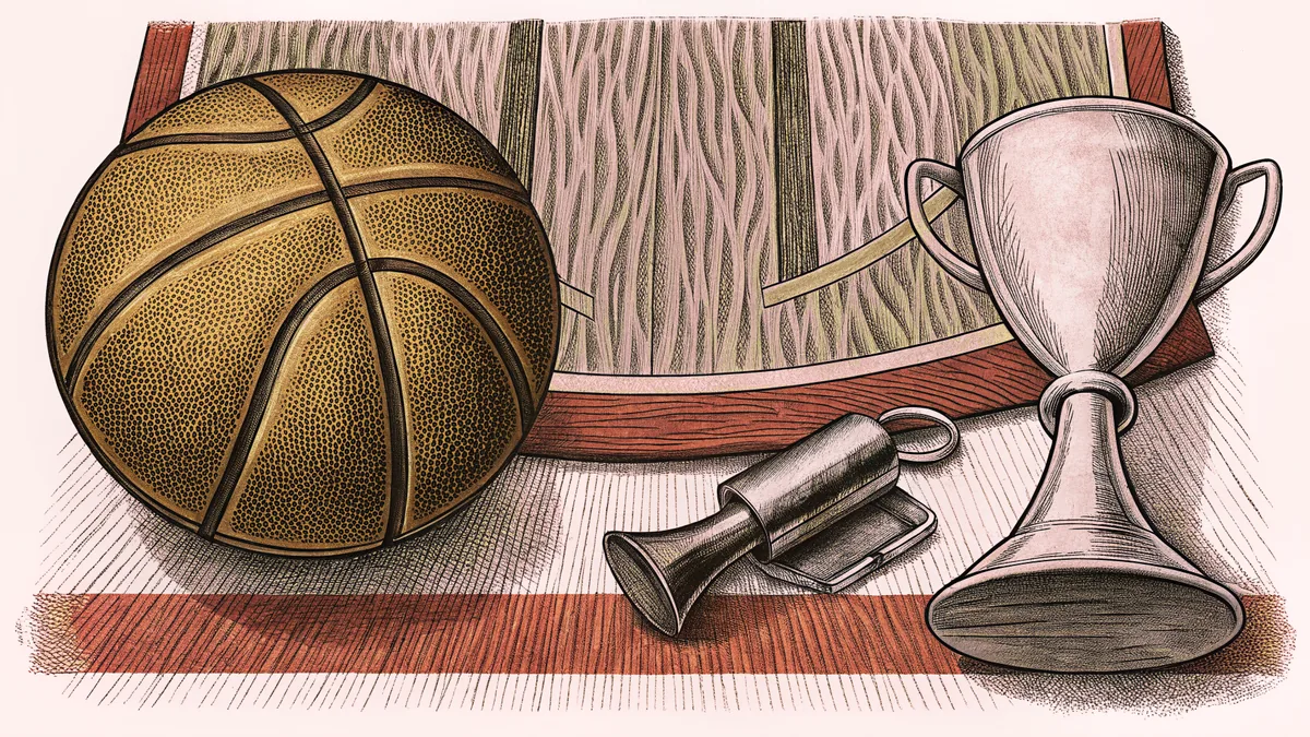 A leather basketball rests on a glossy court floor next to a golden championship trophy.