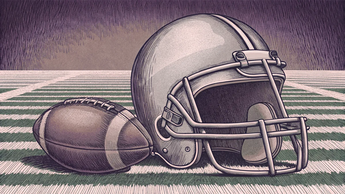 A football helmet and ball sit on a green field with white yard line markers.