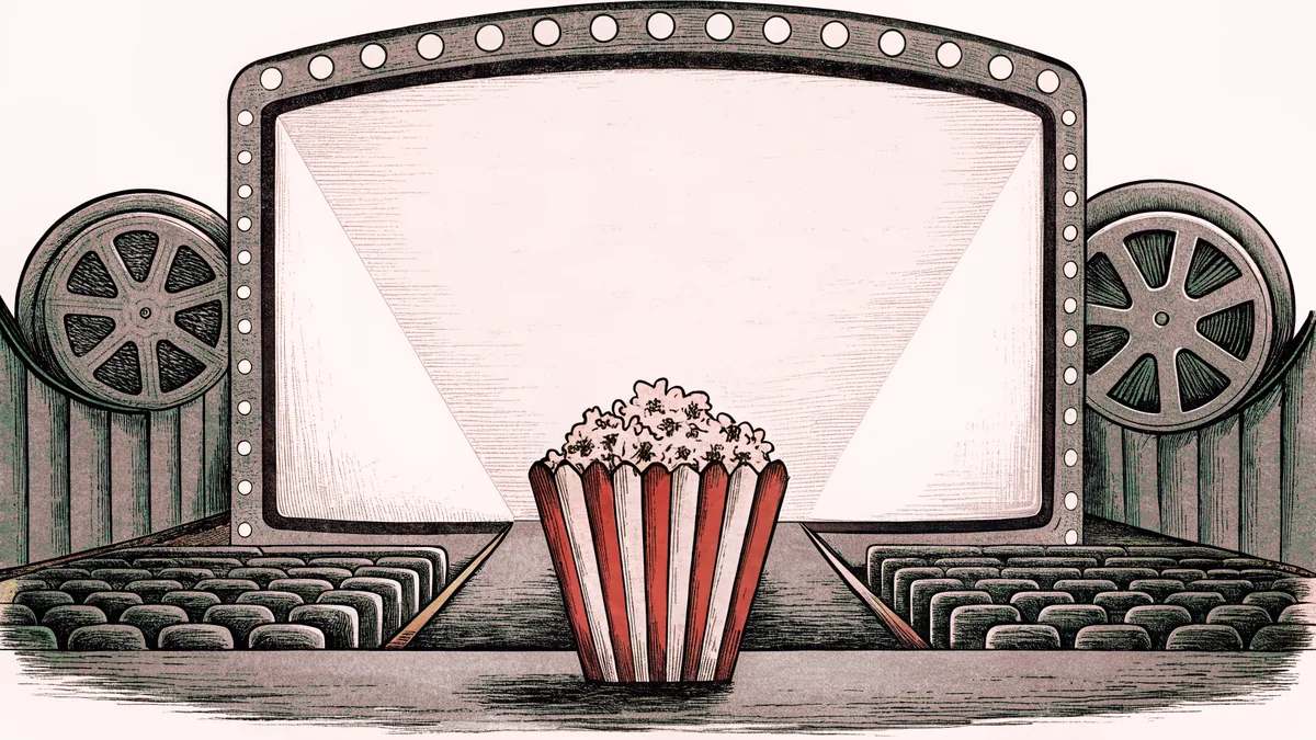 An unmarked theater marquee and spotlight beam shine above a striped popcorn box.