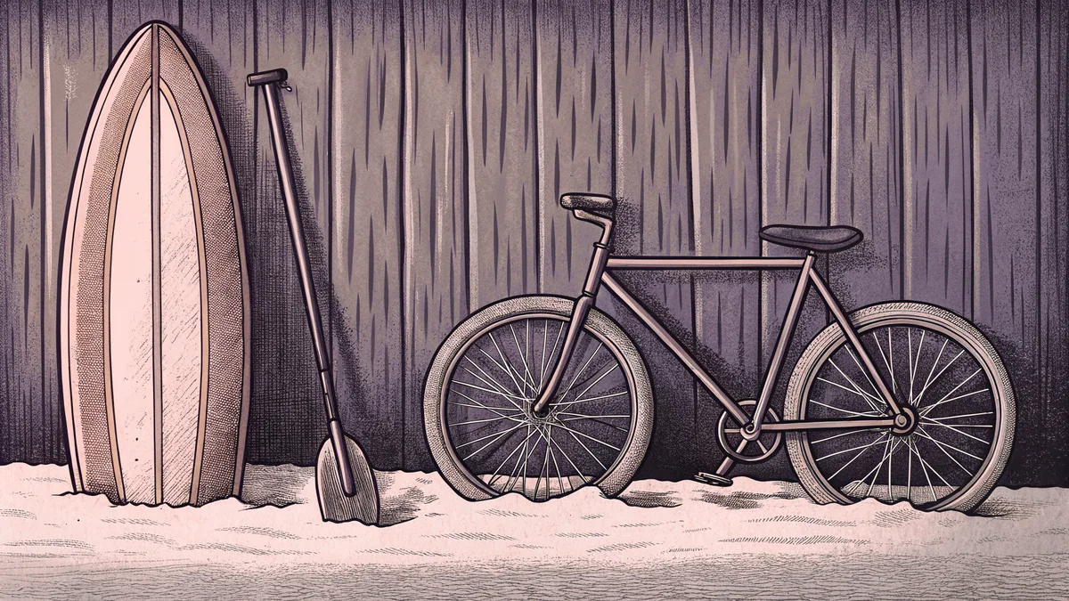 A colorful surfboard leans on golden sand beside a bicycle with a golf club propped nearby.