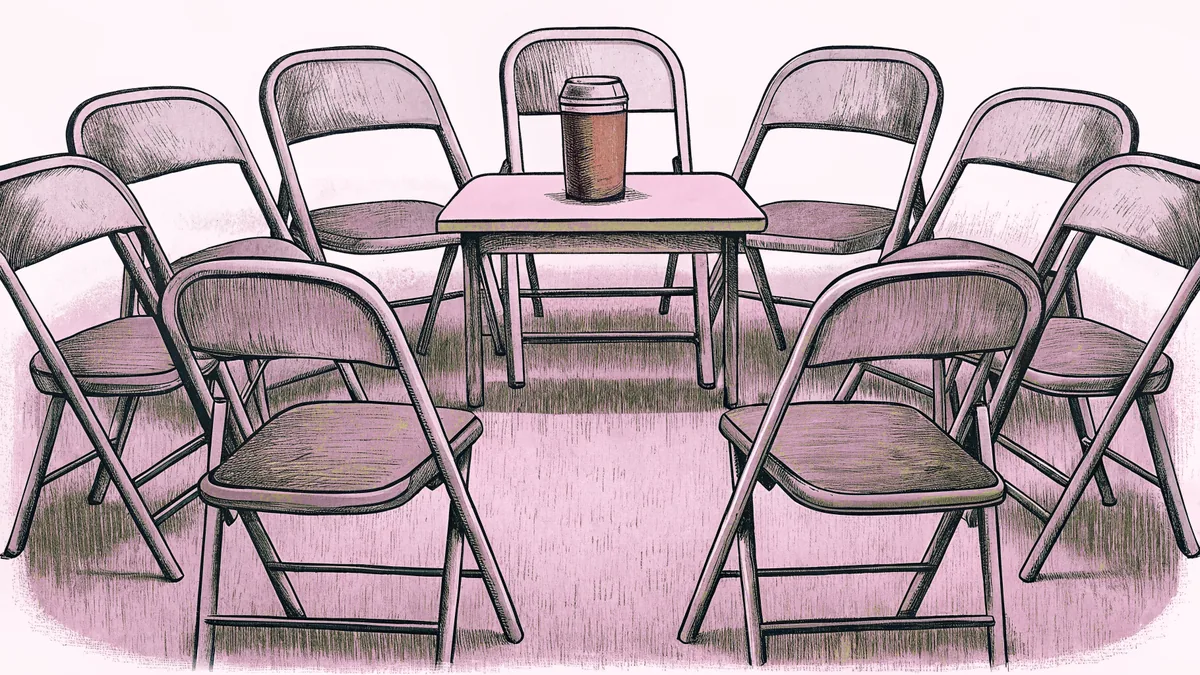 Folding chairs arranged in a circle around a coffee station in a meeting room.
