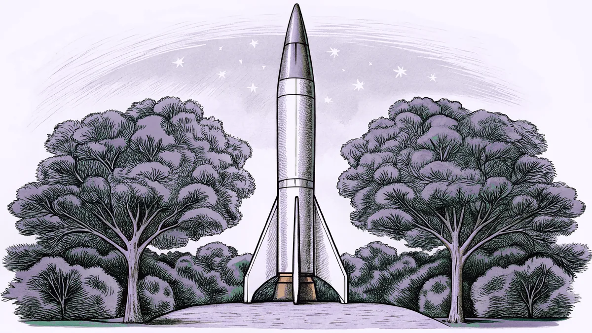 A tall silver rocket with white boosters stands ready on a launch pad.