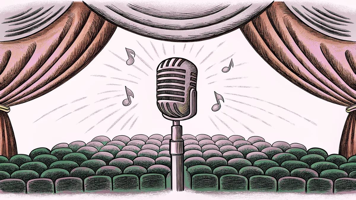 A concert stage with an illuminated microphone, red lighting, and empty audience seats.