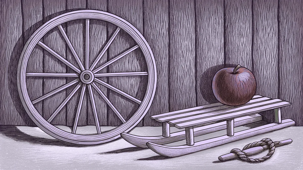 A red apple sits beside a wooden sled and a single bicycle wheel against a grey wall.