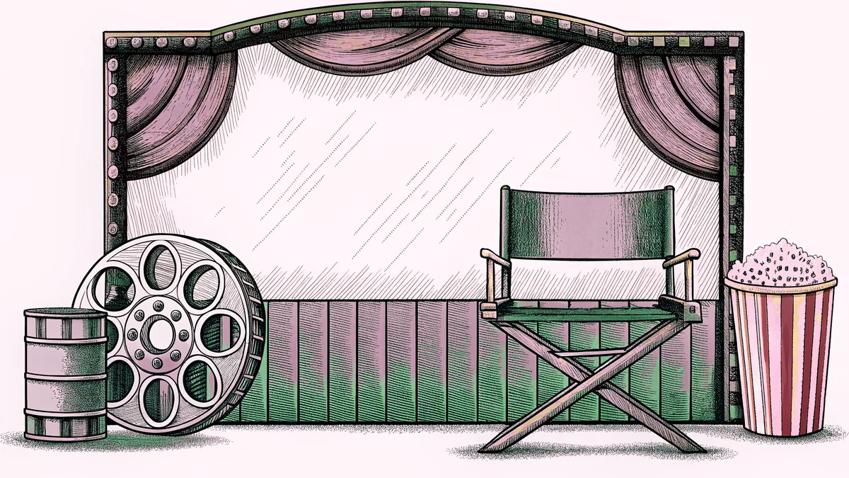 A brass film reel and director's chair sit beside a striped popcorn box on a plush lobby rug.