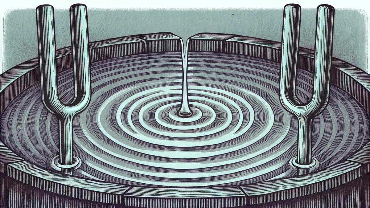 Two tuning forks vibrate beside a struck drum as ripples spread across a bowl of water.