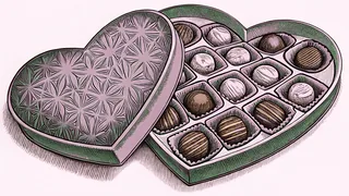 A heart-shaped box of gourmet chocolates overflows with truffles and ganache.