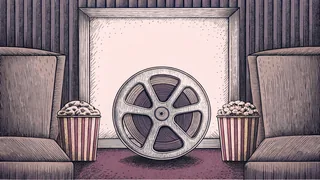 A popcorn box and cinema seat sit near a spinning film reel on a carpet.