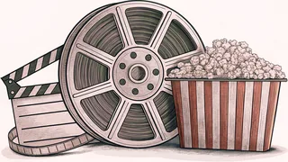 A film reel and clapper board rest next to a striped popcorn box on a workbench.