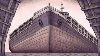 A large ship at anchor with its mast, bridge structure, and hull clearly visible.