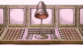 An illuminated on-air lamp glows beside a complex control console with lit switches in a broadcast control room.