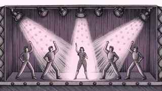 A performer on stage in a sparkling outfit surrounded by stage lighting and dancers.