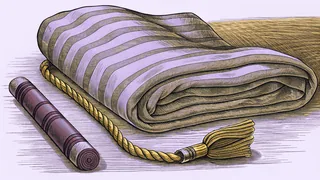 A woven bookmark with a tassel beside a highlighter pen and a folded blanket.