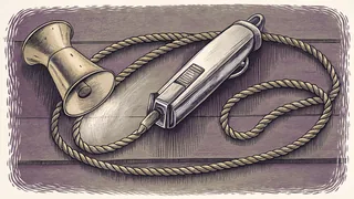 A pair of barber clippers and the flared bell of a brass trumpet, beside a coiled length of cord.