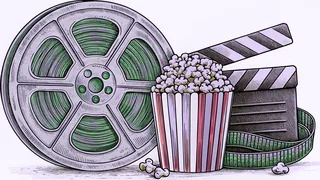 A brass film reel and clapper board rest beside a striped popcorn box on a counter.