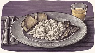 A plate displays scrambled eggs, crispy bacon, and golden toast beside a glass of juice.