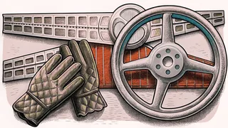 A pair of quilted driving gloves rests against a polished alloy wheel beside a chrome trim strip.