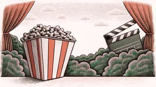A striped popcorn box sits beside a clapper board on a cinema counter.