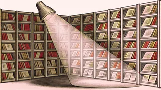 A theatrical spotlight highlights unmarked comic books stacked in shadow and light.