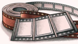 A film reel sits beside an unmarked ticket stub on a lobby counter.