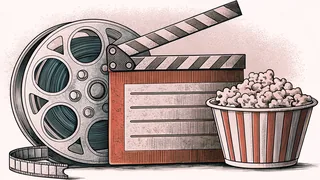 A film reel and unmarked clapper board sit beside a popcorn box on a theater ticket counter.