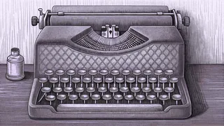 An art deco typewriter with crystalline accents sits beside an inkwell on mahogany furniture.