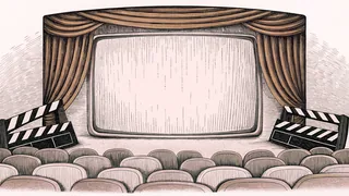 A classic boxy television and blank clapper board rest together on a studio floor under studio lights.