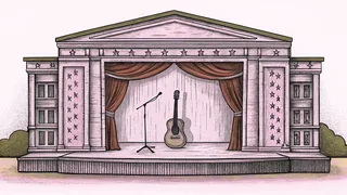 An acoustic guitar leans beside a vintage microphone on a concert stage.