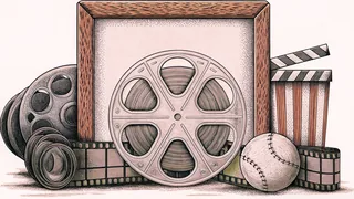 A vintage film reel sits with various sports balls and equipment on display.
