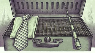 A backyard grill with tongs, a striped necktie draped over a toolbox and a fishing rod nearby.