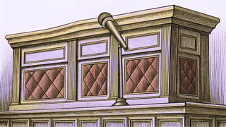 A polished wooden rail with a brass microphone mounted on it, on a carpeted riser.