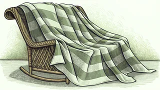 A woven plaid blanket draped over a rocking chair, reaching down to the floor.