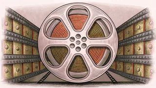 Film projection equipment and colored stage lighting gels arranged on a theater technical console.